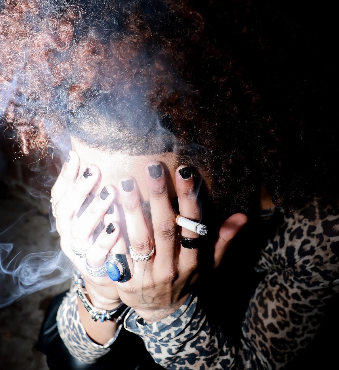 Close-up rock editorial portrait with statement rings and leopard print