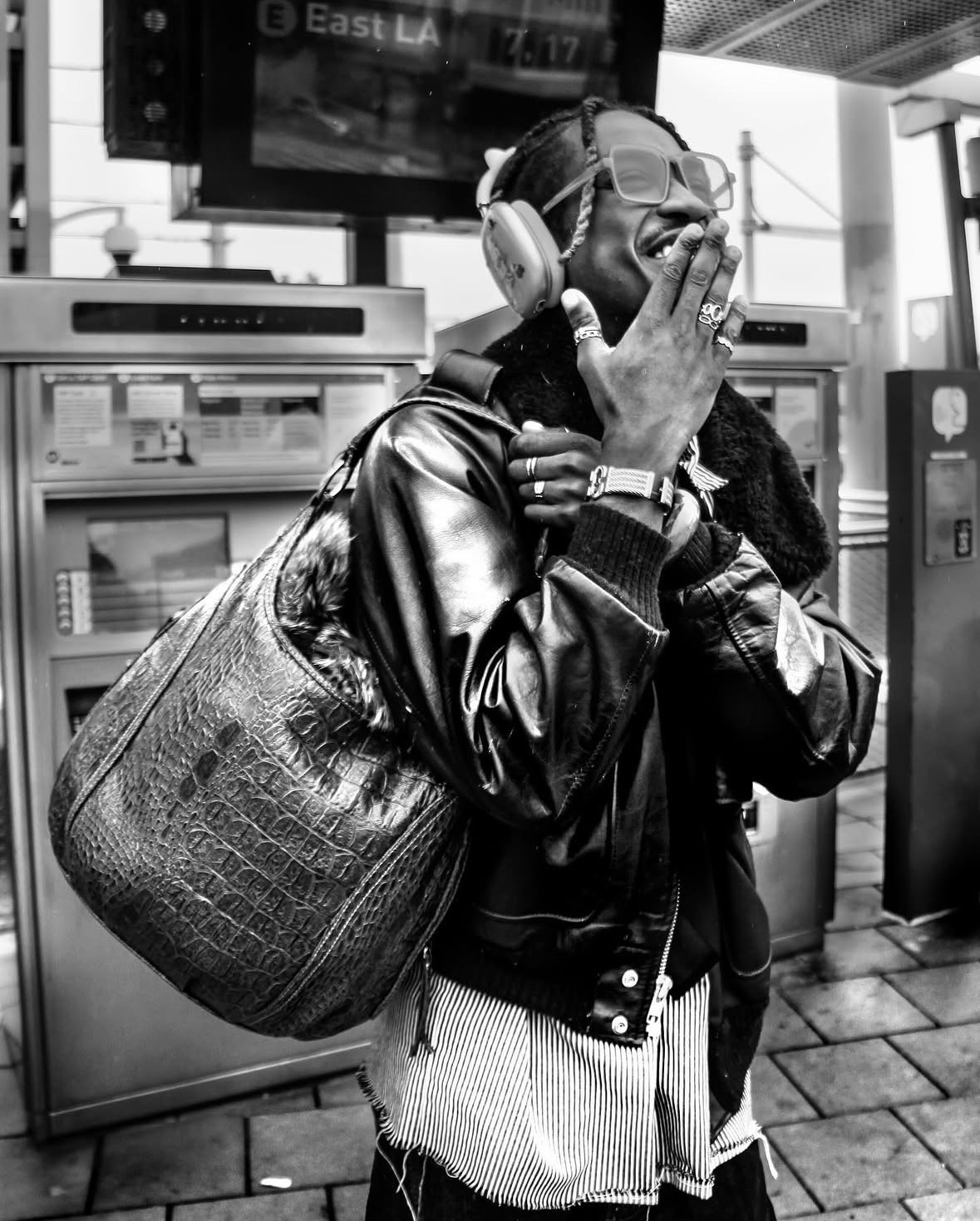 Black-and-white portrait with oversized bag and headphones