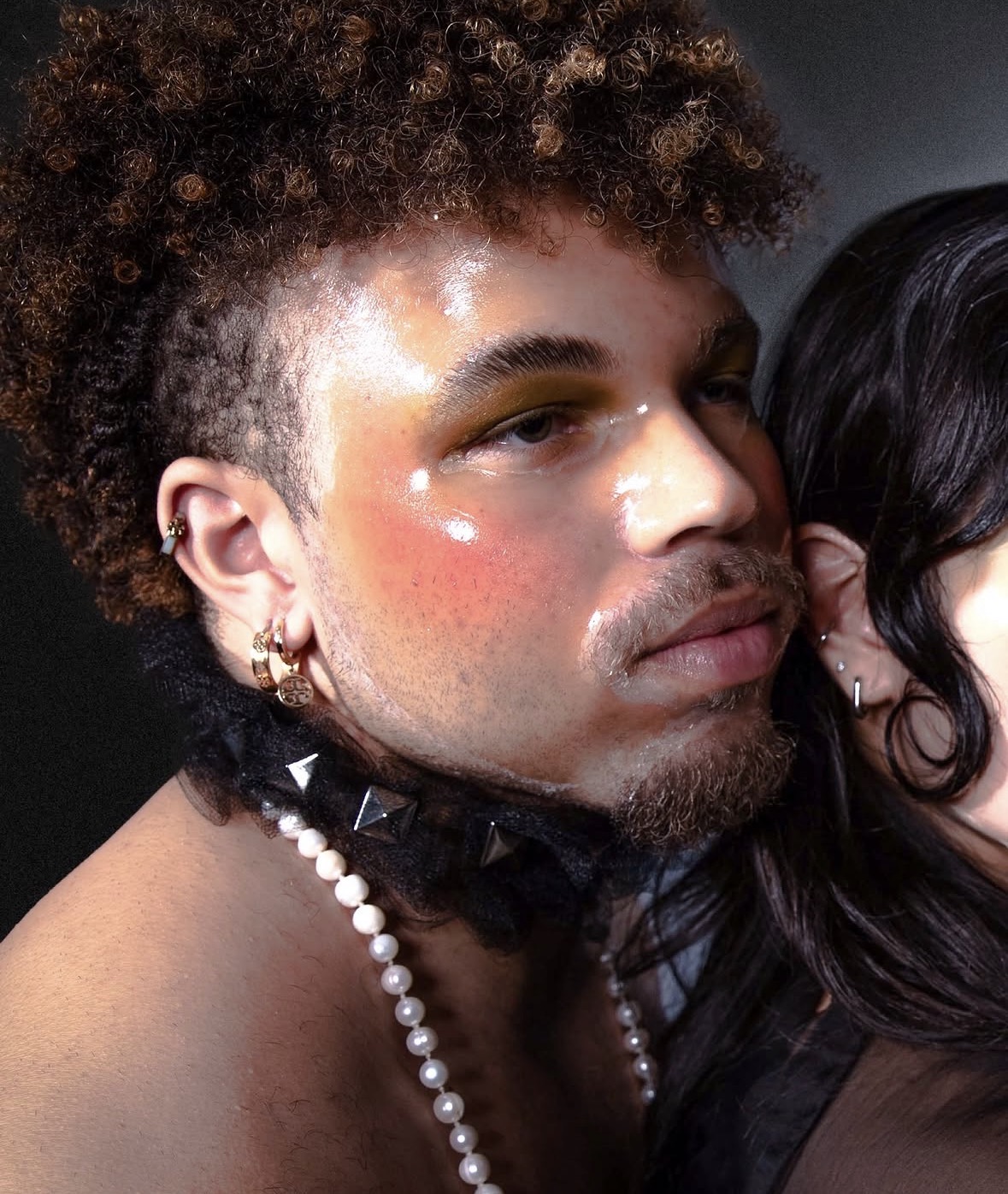 Close-up beauty portrait featuring a handmade black-and-pearl choker